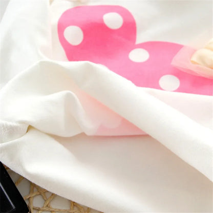 Close-up of a baby girl's t-shirt with an adorable bow dot pattern, part of a cute outfit