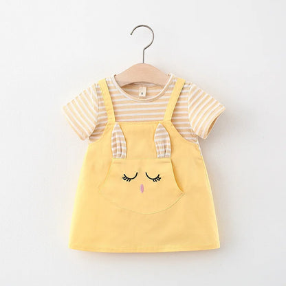 Studio shot of a baby girl's striped princess dress with a delightful cartoon cat design.