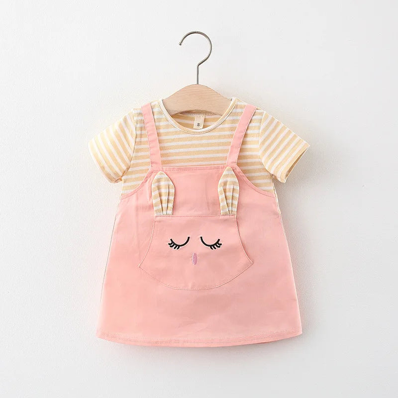 Close-up of cartoon cat embroidery on a striped baby girl's princess dress. Cotton blend.