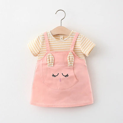 Close-up of cartoon cat embroidery on a striped baby girl's princess dress. Cotton blend.