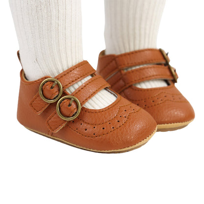 Toddler girl's anti-slip first walker shoes in white with a secure hook and loop buckle design.