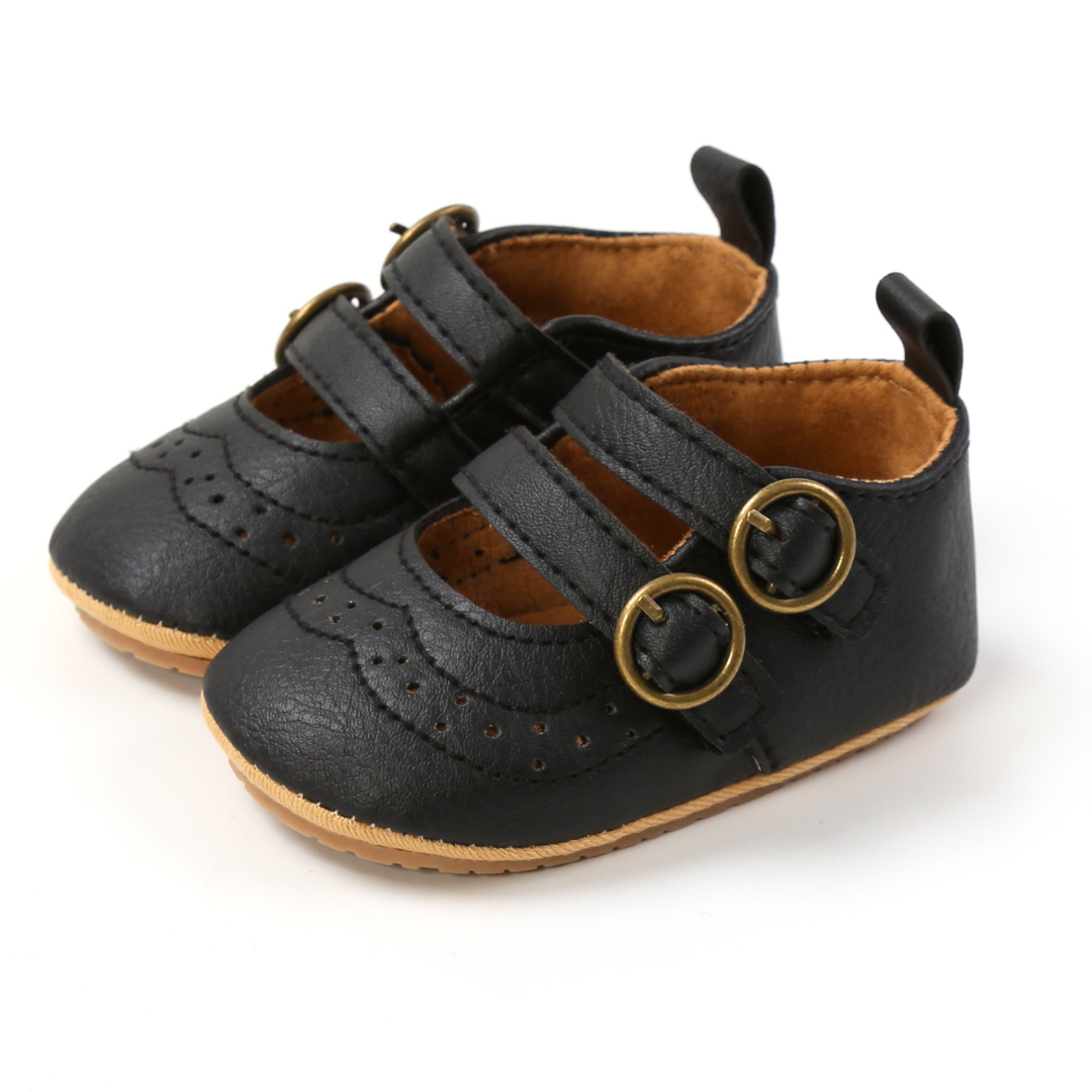 Elegant black first walker shoes for baby girls with classic buckle and convenient hook and loop closure.