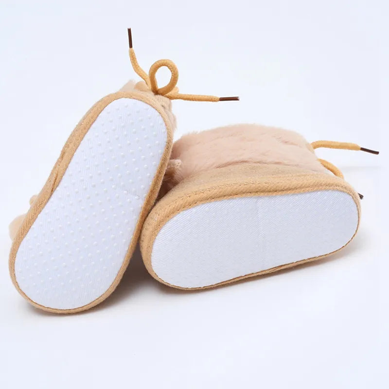 Pink baby girl's winter booties, soft sole and stylish fluff ball for warmth and comfort