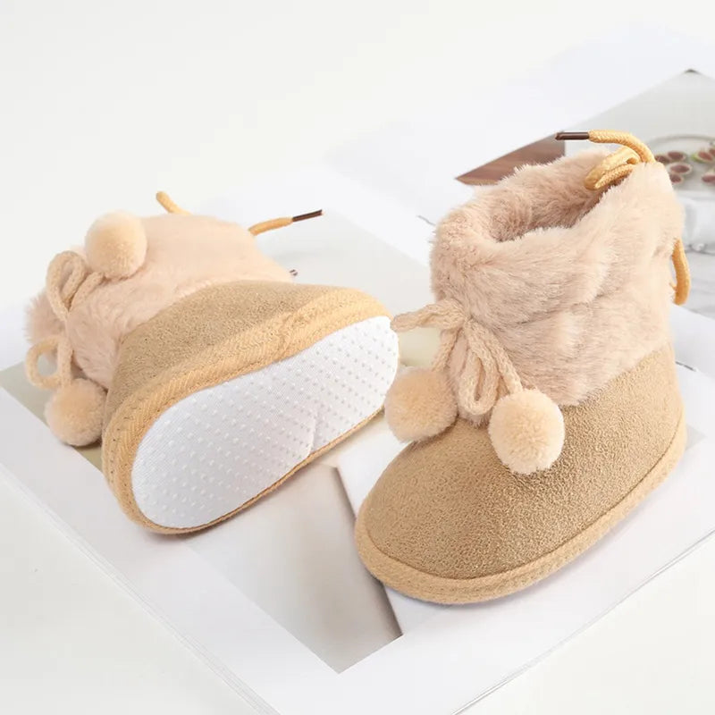 Charming pink baby girl winter boots with fluff ball, soft sole for tiny feet, cozy infant