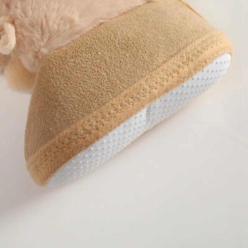 Baby girl infant footwear: pink winter snow booties with a cute fluff ball, soft sole design