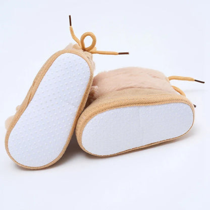 Pair of baby girl's pink winter snow booties, soft sole and cute fluff ball design, newborn