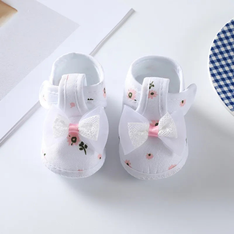 Baby girl's floral bow soft-soled crib shoes, pink with elegant flower pattern, comfortable infant footwear.