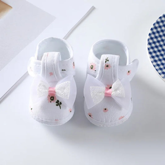 Baby girl's floral bow soft-soled crib shoes, pink with elegant flower pattern, comfortable infant footwear.