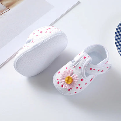 Front view of baby girl's floral soft-soled crib shoes, with an adorable pink bow on top, cute infant shoes.