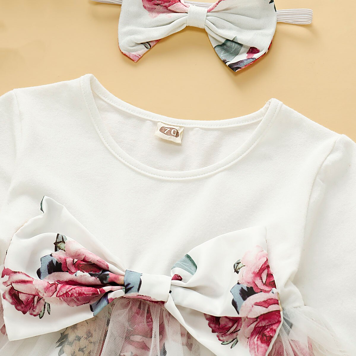 Cute baby dress with long sleeves, decorated with an all-over floral and butterfly print.