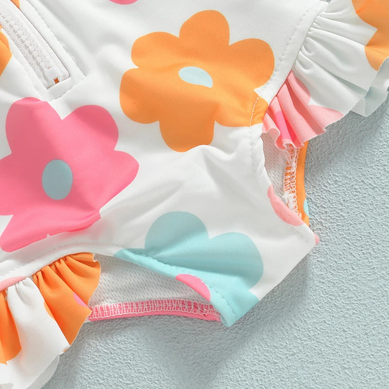 Baby girl's playful floral ruffle one-piece swimsuit, ideal for splashing around in the pool.