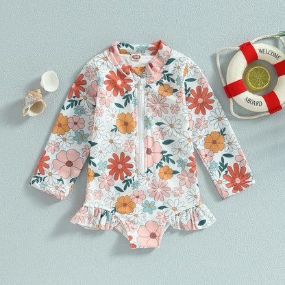 Pretty baby girl's floral one-piece swimsuit with adorable ruffles, perfect for infant pool days.
