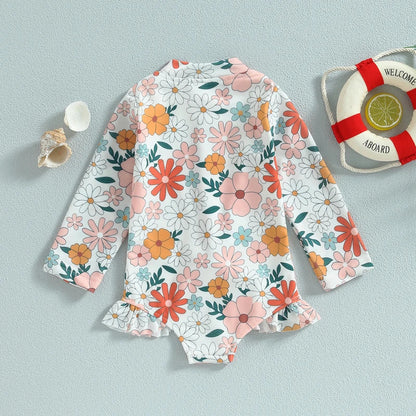 Baby girl's vibrant floral print one-piece swimsuit with ruffles, essential summer beachwear.