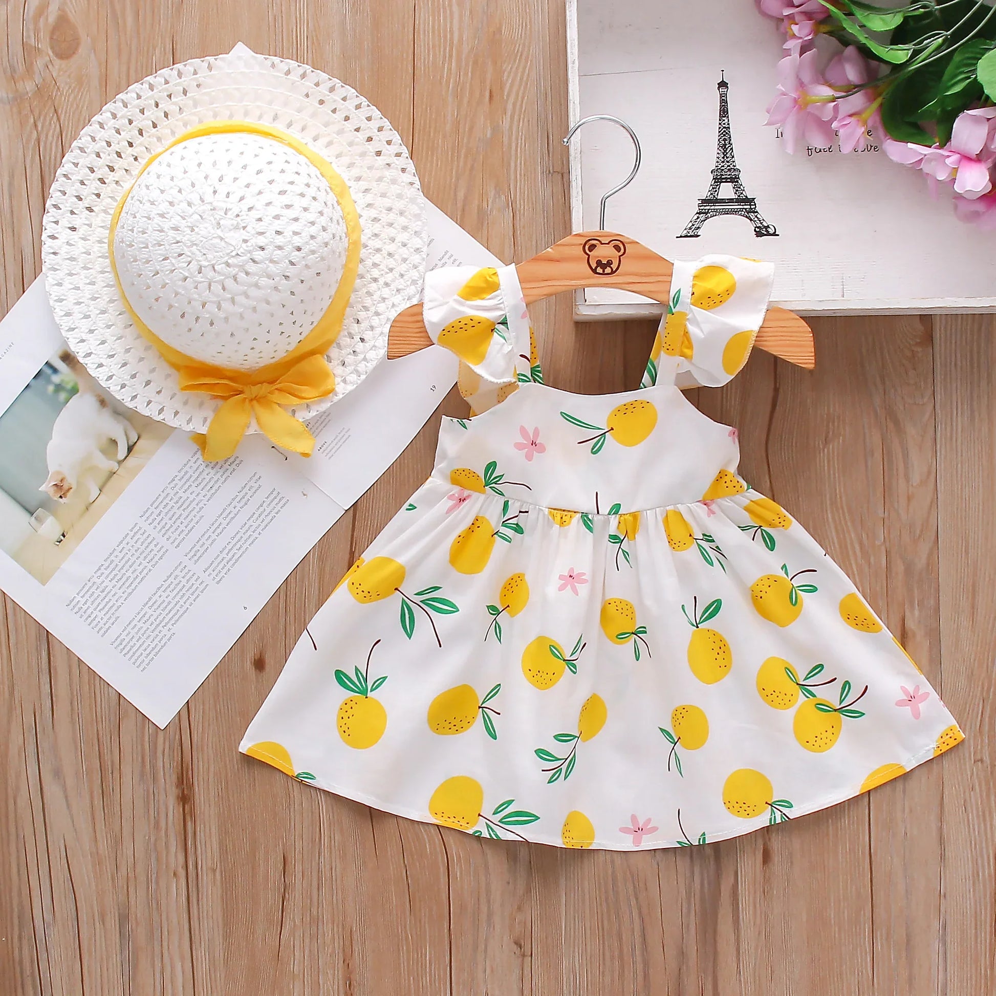 Infant girl's soft cotton fruit print dress and hat set, comfortable spring outfit.