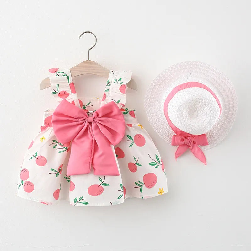 Stylish toddler girl's fruit pattern cotton dress with a sweet bow and sun hat.