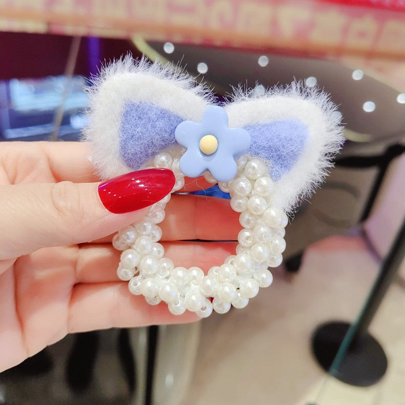 Cute baby girl wearing a pearl-studded crown headband, ideal for photo props and parties