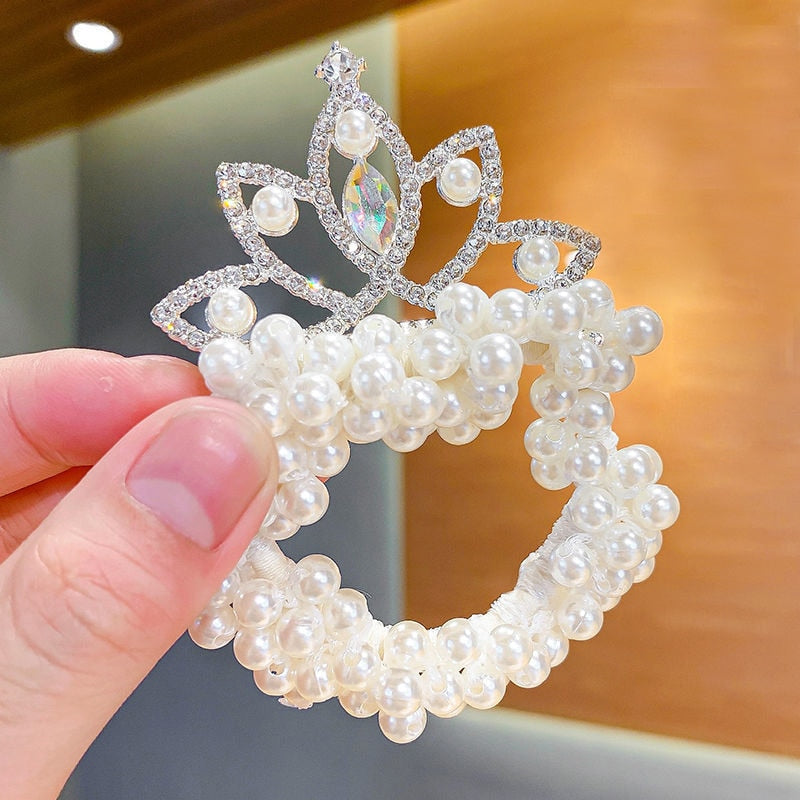 Infant girl's soft elastic headband with a decorative pearl crown, gentle on baby's head