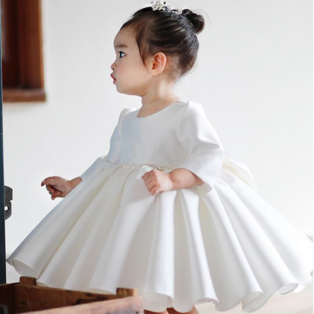 White baby girl christening dress with pearl embellishments, ideal as a special occasion outfit.