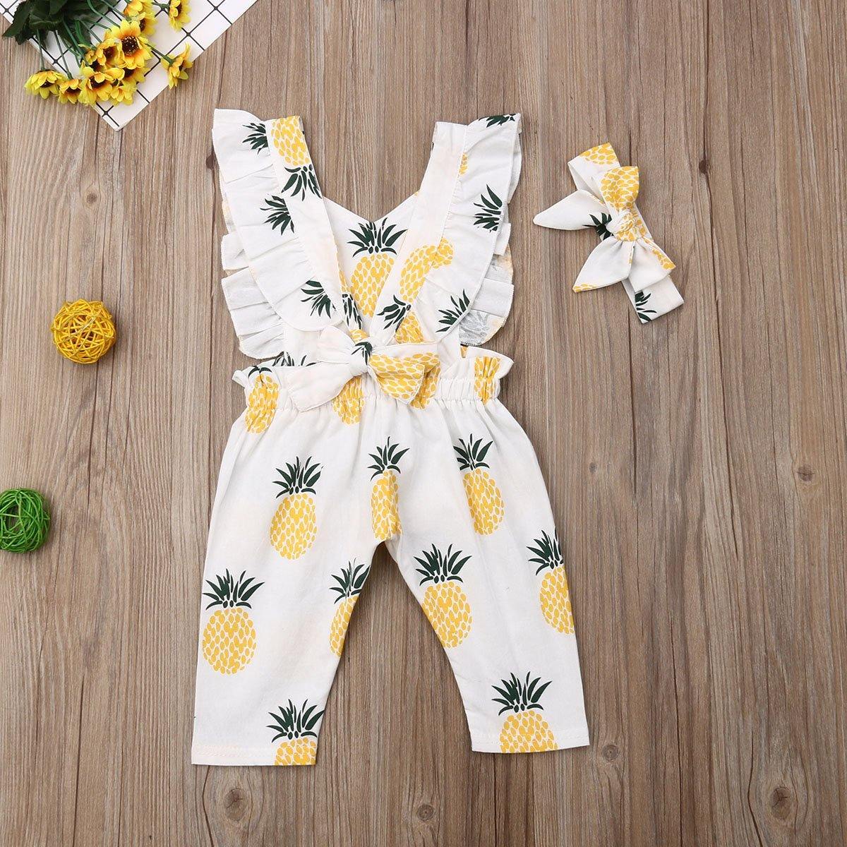 Close-up of an infant girl's pineapple print romper and headband set, showcasing the vibrant design