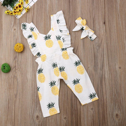Full view of a baby girl's fashion ensemble: a charming pineapple print romper and a comfortable headband