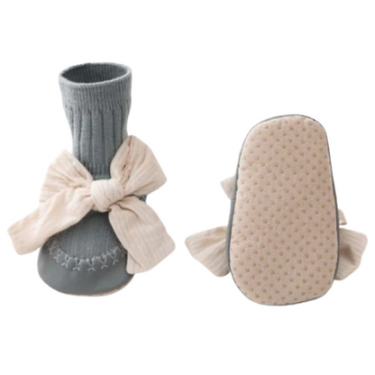 Front view of baby girl's anti-slip cotton sock walker shoes in grey with a cute bowknot accent