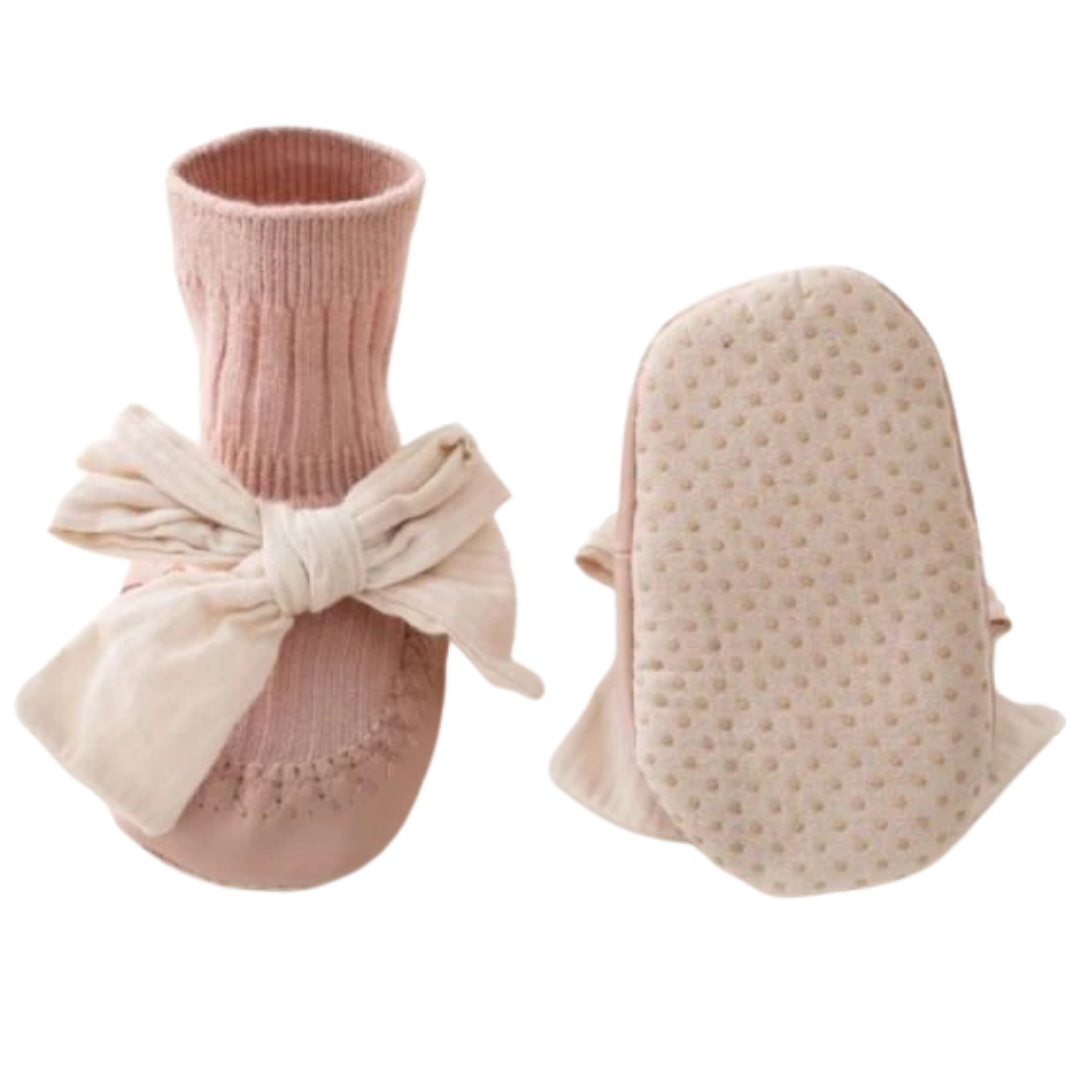 Top-down view of baby girl's cotton sock walker shoes with anti-slip soles and a classic bowknot