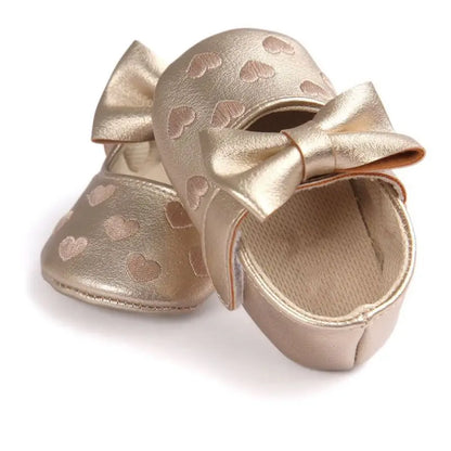 Close-up of the anti-slip sole texture on pink baby girl first walker shoes, soft and safe
