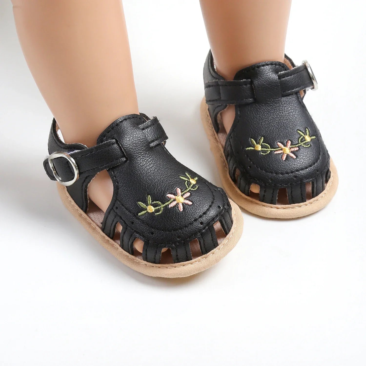Side profile of a baby girl's ergonomic, lightweight summer sandal for active infants