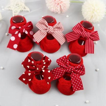 Tiny baby girl cotton socks with anti-slip soles and a sweet blue bow