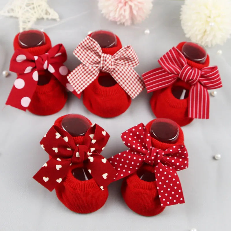 Baby girl wearing soft cotton anti-slip bow socks, perfect for crawling