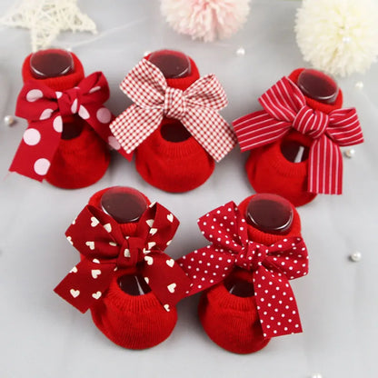 Baby girl wearing soft cotton anti-slip bow socks, perfect for crawling