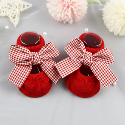 Detail of anti-skid sole on baby girl's cotton bow socks for safe play