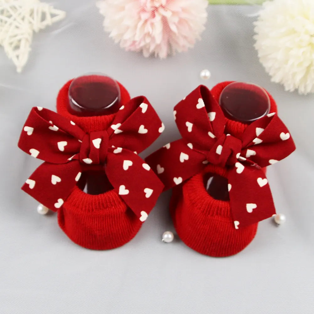 Close-up of the delicate bow detail on infant anti-slip cotton socks
