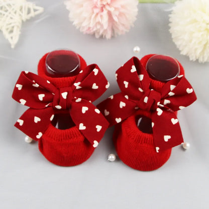 Close-up of the delicate bow detail on infant anti-slip cotton socks