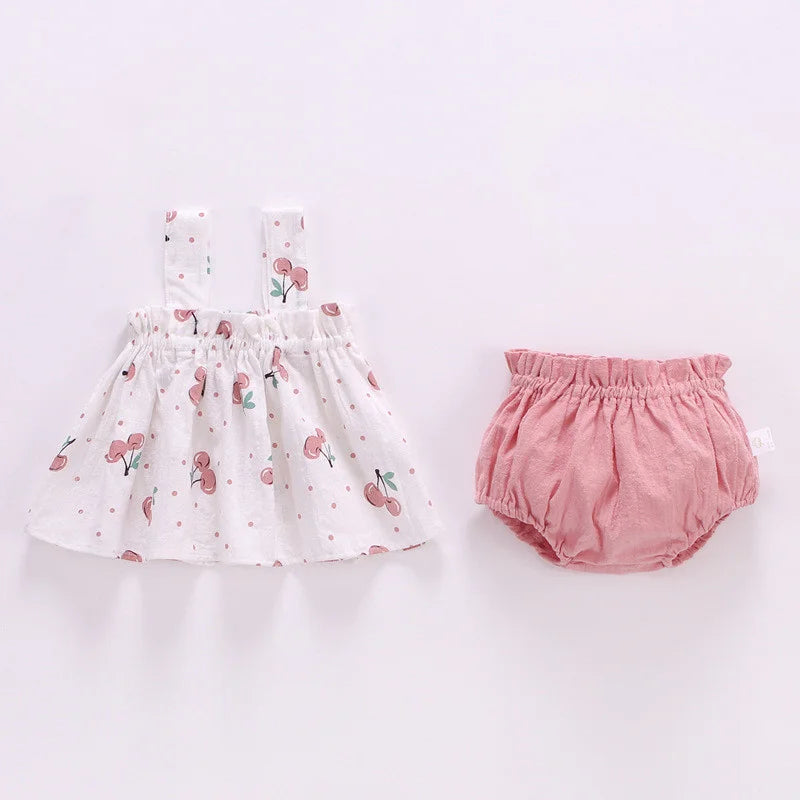 Close-up of square collar on baby girl's summer mini dress, featuring soft pink cotton blend fabric