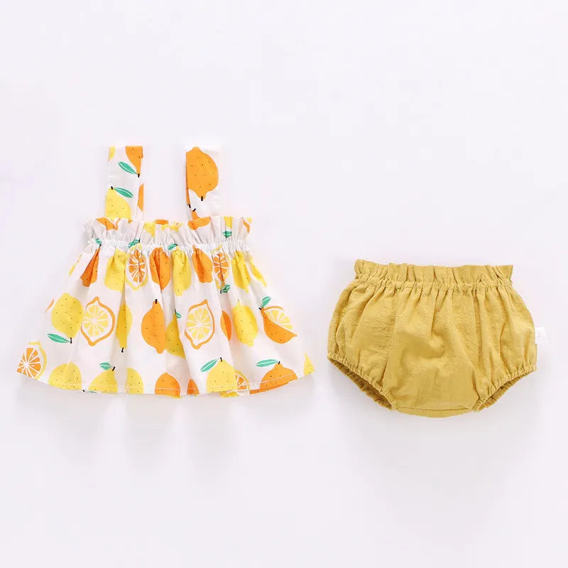 Cute newborn baby girl wearing a pink summer mini dress with a square collar and ruffled sleeves