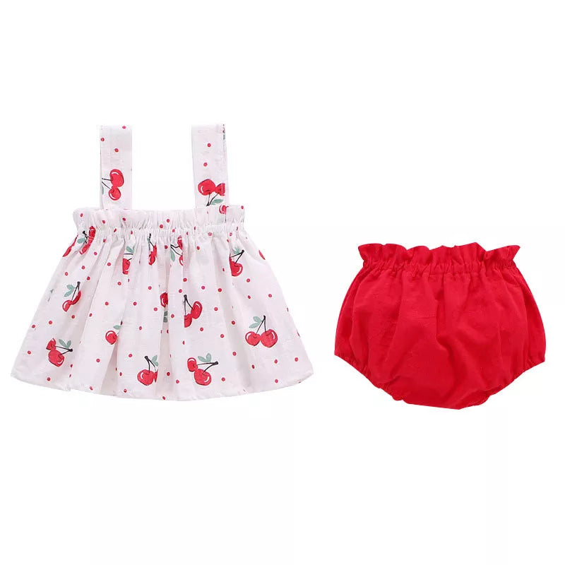 Close-up of the delicate ruffled sleeves on a baby girl's pink cotton blend summer dress