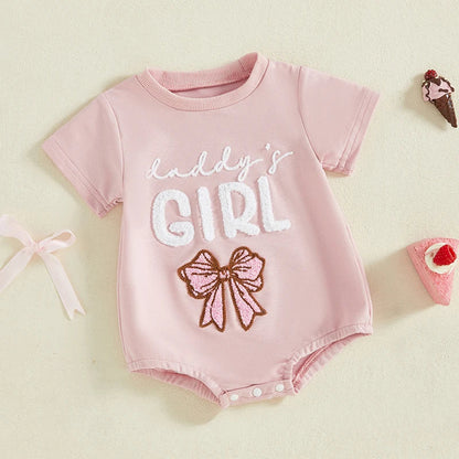 Close-up of 'Daddy's Girl' embroidery on pink cotton blend baby girl romper, summer infant clothes