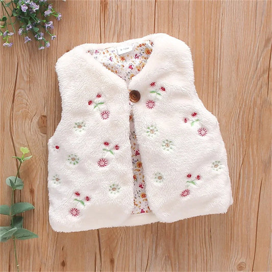 Baby girl's pink faux fur vest with delicate flower embroidery, cozy winter outerwear.
