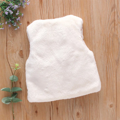 Close-up of flower embroidery on a soft pink baby girl's faux fur vest, winter fashion.