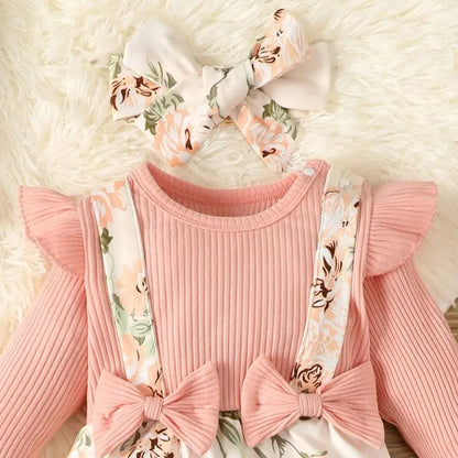 Close-up of pink floral baby romper, showing delicate spring autumn floral pattern on cotton blend