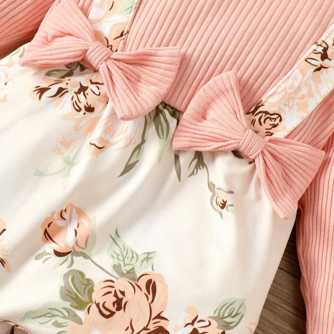 Full view of a baby girl's pink floral romper jumpsuit, perfect for infant spring autumn wear