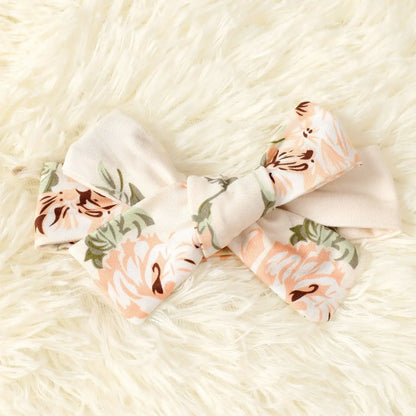 Adorable baby girl in a pink floral romper, stylish one-piece cotton blend infant outfit