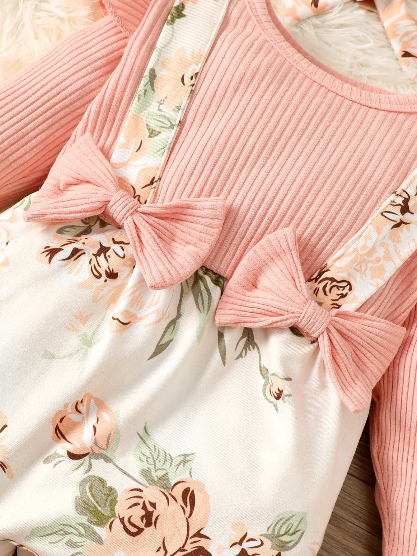 Front view of a pink floral baby romper, a cute and comfortable spring autumn infant clothing option