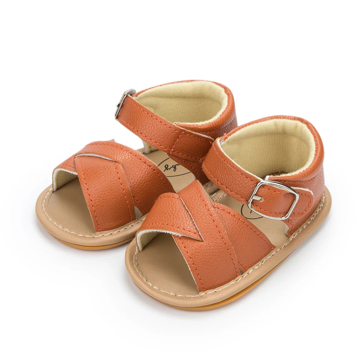 Close-up of the anti-slip sole on a baby girl's flower sandal, flat heel