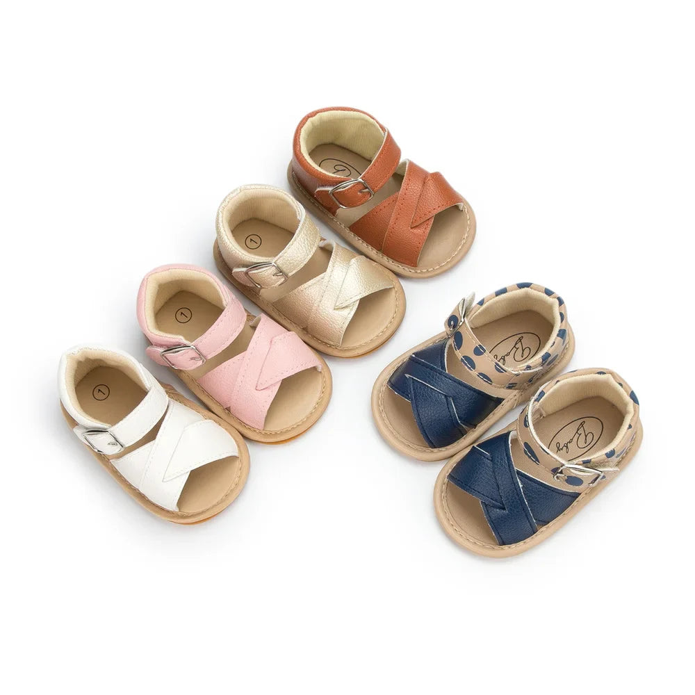 Side view of pink baby girl's PU leather flower sandals with an adjustable strap