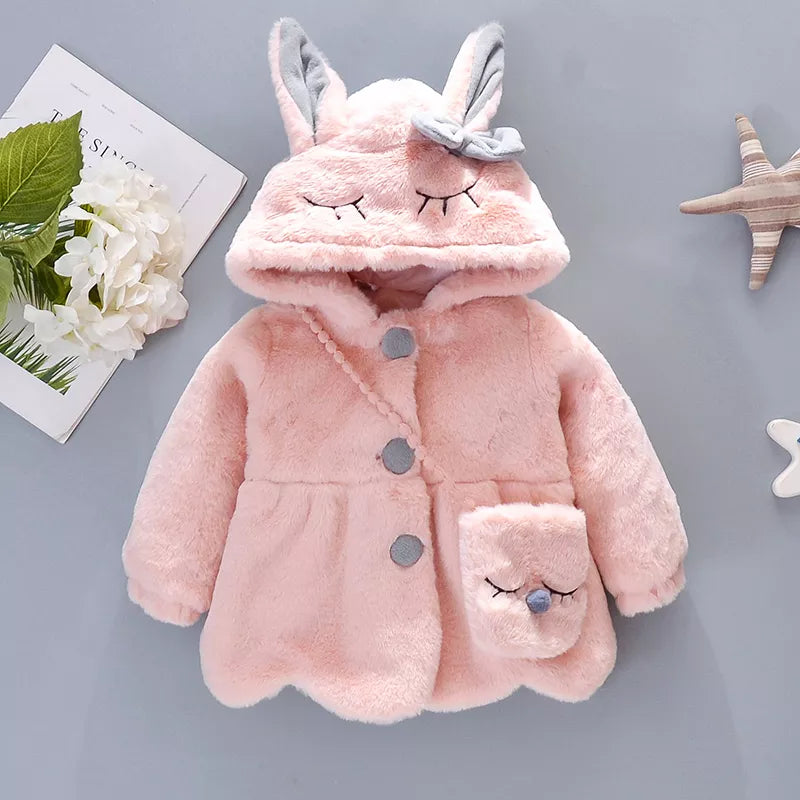 Close-up on the zipper of baby girl's rabbit ears hooded winter jacket, high quality.