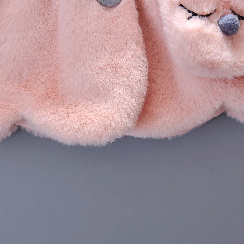 Close-up of the hood and rabbit ears on baby girl's cozy winter jacket.