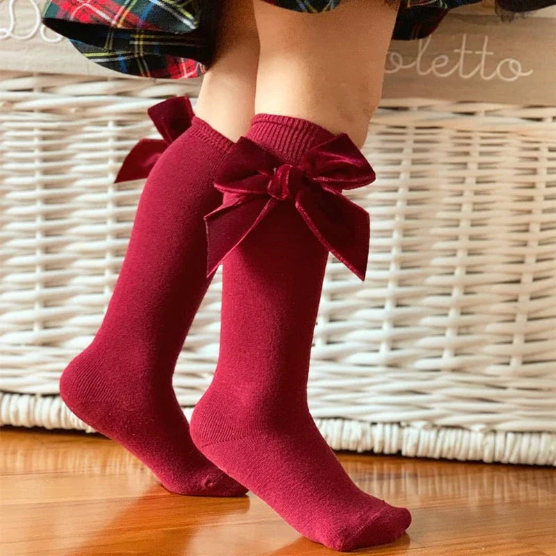 Cute yellow knee-high socks for baby girls, featuring a charming bow knot detail.