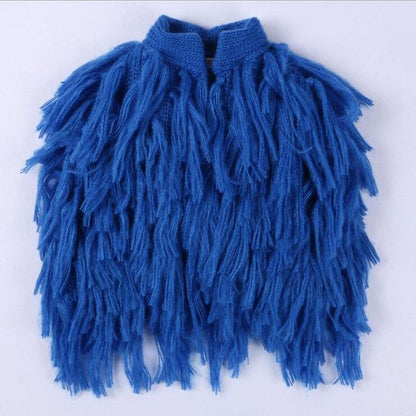 Knitted baby shrug in a vibrant color, featuring cute tassels and sleeveless design, children's fashion.